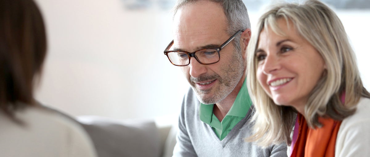 Senior couple meeting financial adviser for investment